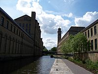Leeds and Liverpool Canal in Saltaire — Salts Mill at the left and New Mill on the right