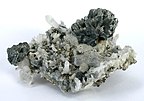 A spray of semseyite crystals perched, freestanding, at the apex of a cluster of quartz crystals. Herja Mine (Kisbánya), Baia Mare (Nagybánya), Maramureș County, Romania