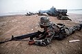 An Ecuadorian Marine with a HK-33 rifle, during an amphibious assault exercise (UNITAS), in the background a US Amphibious Assault Vehicle.