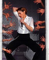 A Woman wearing a white shirt and black trousers