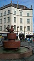 The granite fountain "Fugl med Guldæble" (Bird with Golden Apple) and the Regina building in the background