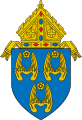 The arms of the Archdiocese of Los Angeles: The arms feature three pairs of wings, denoting three angels, and referencing the namesake of the see, Los Angeles, California, which translates to "the angels."