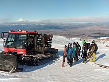 Skiers and snowboarders are dropped off at the Tukino ski field upper boundary by the cat skiing service.