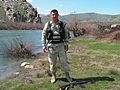 A Kurdish Army PDK Peshmurga "Special Forces" Soldier places his 5.45 mm AK-74 assault rifle on the ground to pose for a photograph at a river stream located in the countryside near Dohuk, Iraq, during Operation IRAQI FREEDOM. Photo by: JIM GORDON, CIV Date Shot: 21 Aug 2005