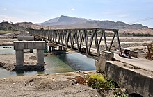 The Manatuto Bridge under construction in 2018, with the 1984 bridge at right