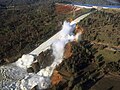 The spillway as it disintegrates under the load of the water spilling over it.