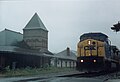 A CSX GE C40-9W locomotive rolls past the Coraopolis Railroad Station in the rain