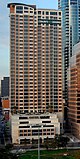 Elevated view of The Ashton from south in the Hyatt Regency Hotel. The tower has a white base, while the tower is brick/crimson red color.