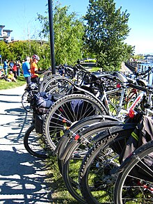 Cyclists park their bicycles on a rack during a "Go By Bike Week" barbecue event