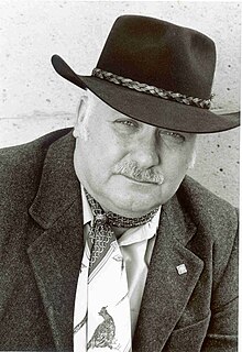 Photograph of Stanley Coren wearing Western-style hat and scarf