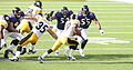 Parker running against Ravens players (left to right) Haloti Ngata, Ray Lewis, and Terrell Suggs, 2006.