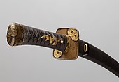 Wakizashi mounting decorated with images of old coins. 1800s. The Metropolitan Museum of Art