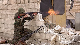 An IRPGF fighter firing at enemy positions in Tabqa