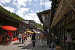 Small street lined by wooden two-storeyed houses.