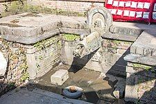 Yaksha beneath the spout of Lun Hiti, Bhaktapur