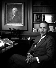 Photograph of Ross Perot sitting at a desk.
