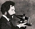 Image 45Actor portraying Alexander Graham Bell in a 1932 silent film. Shows Bell's second telephone transmitter (microphone), invented 1876 and first displayed at the Centennial Exposition, Philadelphia. (from History of the telephone)