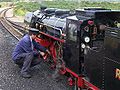 A driver oiling his engine at Dungeness