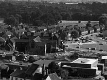 Black and white picture taken from distance, showing one half of the roundabout, the adjacent Whitefriars building, and surrounding housing
