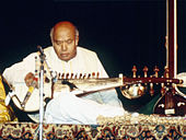 Photograph of an old man playing Sarod