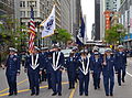 Members of the U.S. Coast Guard and Coast Guard Auxiliary march in a Memorial Day parade in Chicago