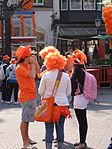 Celebrating Queensday in Amsterdam. The royal family of the Netherlands belong to the House of Orange.