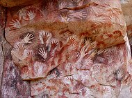 Cueva de las Manos located in Argentina. The art in the cave dates between 13,000–9,000 BP.[4][5]