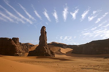 The Moul n'ga Cirque in the Tadrart region, Southeast Algeria, with wave clouds above