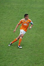 Photographie de Geoff Cameron sur un terrain de soccer avec le Dynamo de Houston.