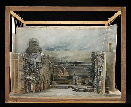 A set design for Giuseppe Verdi's Otello, mixing flats, platforms, and backdrop curtains. Note the "round" tower in the back (as well as other parts) are just painted and shaded to give the illusion of depth, while being a flat piece of wood cut to shape.