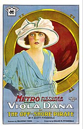 Poster for one of the first cinematic adaptations of Fitzgerald's work—the 1921 silent film The Off-Shore Pirate. The poster features film actress Viola Dana facing the viewer. She is wearing a white broad-rimmed hat and a powder blue dress. Her right hand is wearing a black glove. Behind her is a large circular mirror with a thick gold trim.
