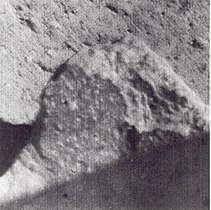 Spotted fragment about 1.5 meters from Surveyor 7 camera. Bright spots have indistinct boundaries and vary from less than 1 mm to about 8 mm across.