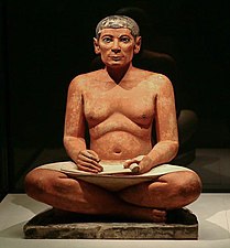 El escriba sentado (Saqqara III milenio a. C. —IV o V dinastía de Egipto—). Representa a un funcionario en actitud de comenzar a escribir, o sea, a registrar un hecho o una interpretación más o menos interesada de hechos seleccionados —económicos, militares, legislativos, religiosos—; una función de consecuencias trascendentales: sirve tanto para el ejercicio y la justificación del poder en su presente como para la preservación de la memoria histórica hacia la posteridad.