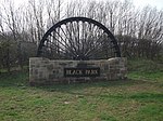 Colliery wheel welcome village sign for Black Park (near Chirk)