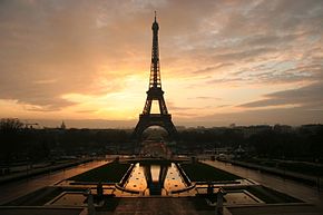 The Eiffel Tower silhouetted by a sunrise.