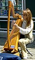 A street musician from Quebec City plays the harp