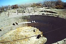 A color picture of a large, circular sandstone ruin