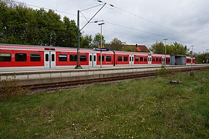 Red-and-white train parked at island platform