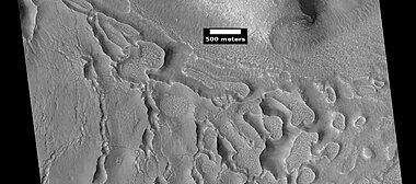 Evolution of ribbed terrain from stress cracks—cracks to the left eventually will enlarge and become ribbed terrain toward the right side of picture, as seen by HiRISE under HiWish program