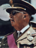 Top of an elderly man in a military uniform and dark glasses