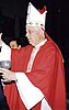Bishop Alejandro Goic is shown wearing a red chasuble and a white miter