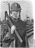 A brown coal miner with a pickaxe. West Germany, 1952