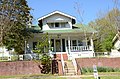 White two-story, green roof