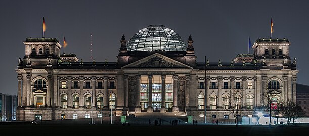 The Reichstag's west facade and illuminated dome at night from Platz der Republik