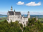 Neuschwanstein castle, a fairy-tale style castle with many towers on the top of a hill