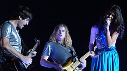 Selena Gomez & the Scene performing on the We Own the Night Tour in September 2011. From left to right: Ethan Roberts, Joey Clement, and Selena Gomez