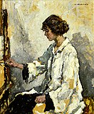 Woman painting at an easel