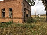 Abandoned bank and church in Mildred, MT