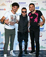 A picture of three men at an award ceremony.
