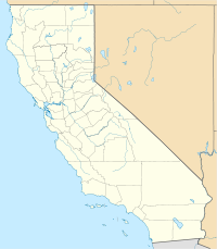 A map of California and its counties, with a flame symbol marking the location of the 49er Fire in the northern third, west of Lake Tahoe